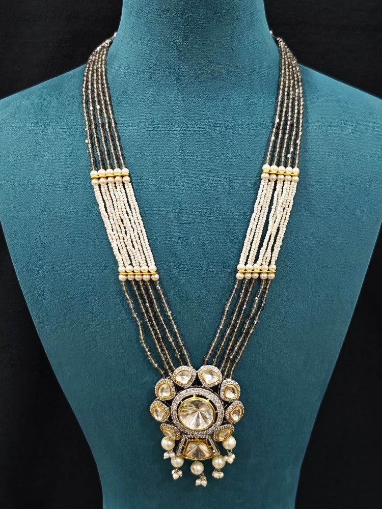 Close-up of an ornate traditional Grey Long jewellery set and earrings with Kundan, American Diamond, pearls and Crystal Beads. Mehendi ceremony look completed with a handcrafted Kundan jewelry set. Wedding guest wearing a lightweight Kundan necklace for a Wedding function.