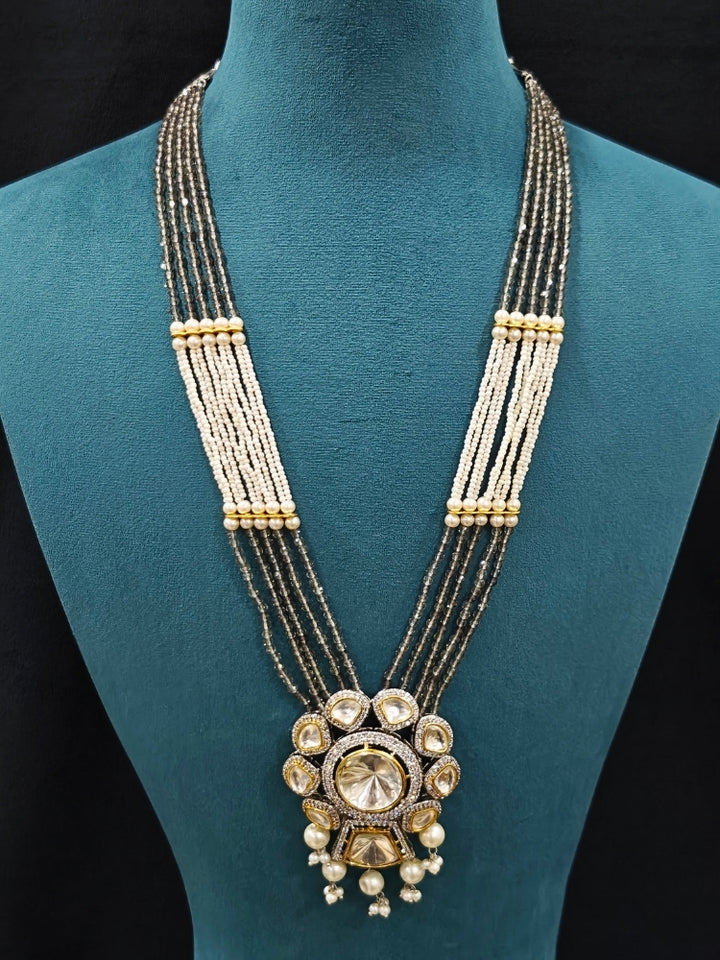 Close-up of an ornate traditional Grey Long jewellery set and earrings with Kundan, American Diamond, pearls and Crystal Beads. Mehendi ceremony look completed with a handcrafted Kundan jewelry set. Wedding guest wearing a lightweight Kundan necklace for a Wedding function.