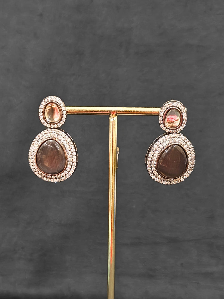 Close-up of an ornate Indo-western American Diamond Grey Collar jewellery set and earrings with American Diamonds and Monalisa Stones. a statement American diamond necklace with an off-shoulder gown for a reception. Close-up of a luxury American Diamond imitation necklace styled.