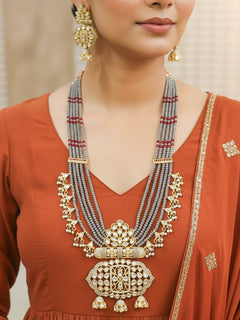Close-up of a woman wearing an ornate traditional Grey Meenakari gold Long jewellery set and earrings with Kundan, Meenakari work, crystal beads, pearls and American Diamonds. Woman wearing a vibrant Meenakari artificial jewelry set for celebrations. Wedding function styling with a premium Meenakari imitation necklace.
