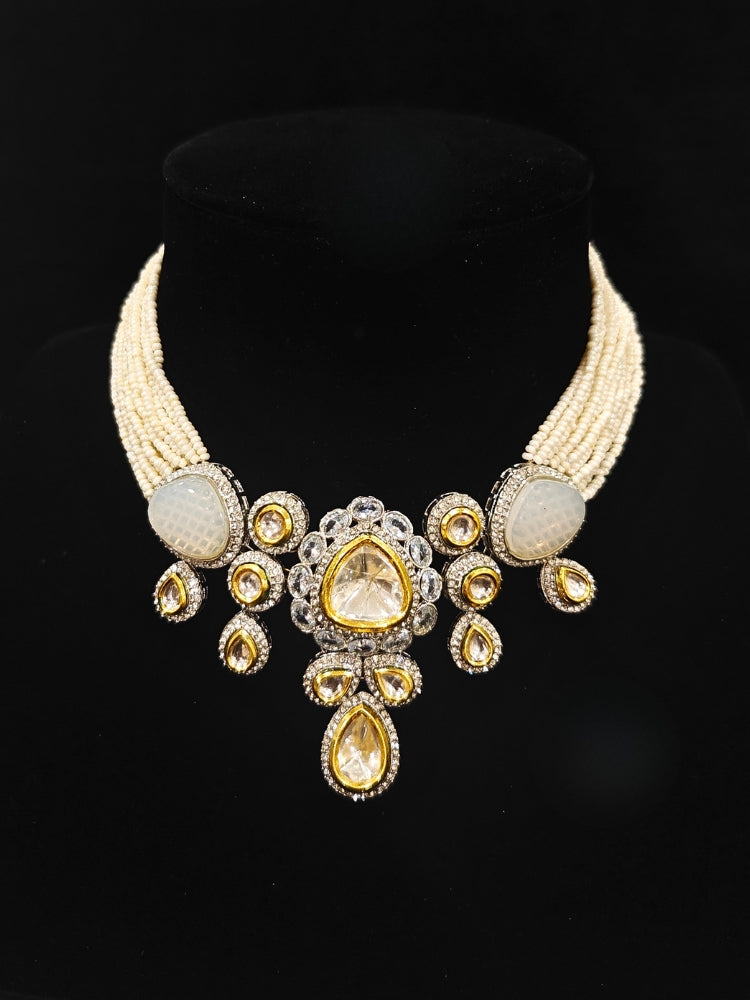 Close-up of an ornate traditional Grey Collar Kundan jewellery set and earrings with American diamonds, Monalisa stone, Pearls, Kundan and Colored Stones. Festive Diwali outfit paired with a premium Kundan jewelry piece. A trending Kundan artificial jewelry for wedding season in India.