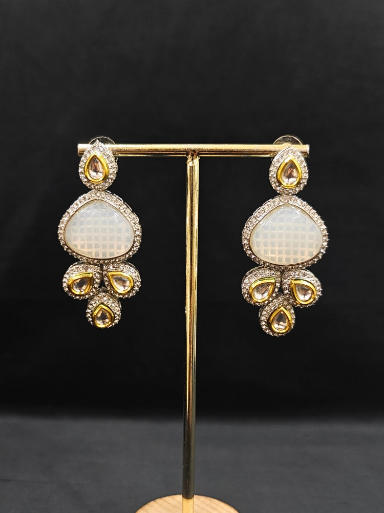 Close-up of an ornate traditional Grey Collar Kundan jewellery set and earrings with American diamonds, Monalisa stone, Pearls, Kundan and Colored Stones. Festive Diwali outfit paired with a premium Kundan jewelry piece. A trending Kundan artificial jewelry for wedding season in India.