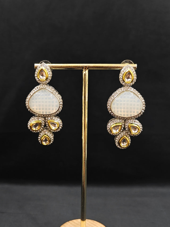 Close-up of an ornate traditional Grey Collar Kundan jewellery set and earrings with American diamonds, Monalisa stone, Pearls, Kundan and Colored Stones. Festive Diwali outfit paired with a premium Kundan jewelry piece. A trending Kundan artificial jewelry for wedding season in India.