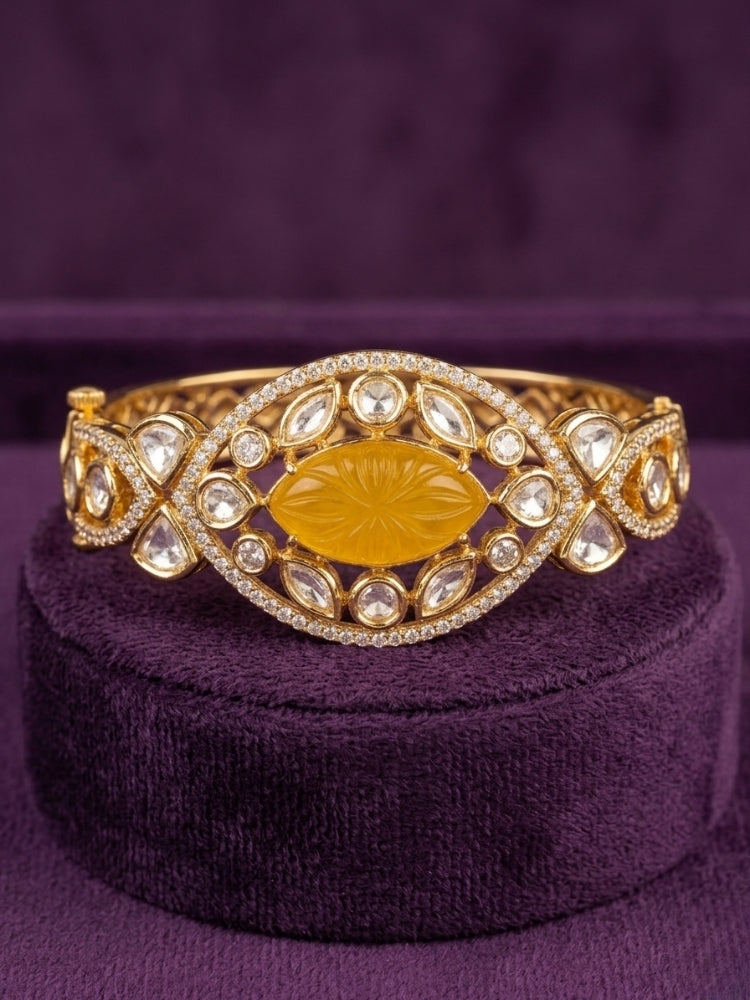 Close-up of an ornate traditional (Gold Polish) Yellow Bracelet with Polki, American Diamond and Yellow Carved Stone. Woman showcasing a premium artificial Polki bracelet for wedding celebrations. Modern saree styling featuring a delicate Polki bracelet.