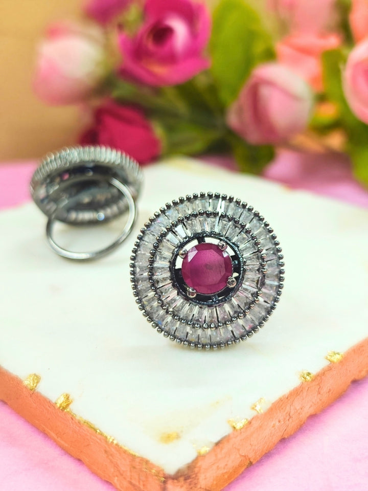 Close-up of an ornate Western (Black Polish Victorian Finish) Red Diamond Ring with American Diamond and Colored Stones. A premium imitation American Diamond ring with festive attire. Party wear styling with a premium imitation jewelry American Diamond ring.