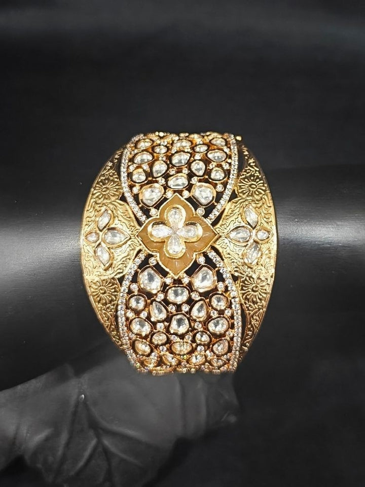 Close-up of an ornate traditional (Gold Polish) Gold Bracelet with Polki and American Diamond. Woman showcasing a premium artificial Polki bracelet for wedding celebrations. Festive Diwali look enhanced with an imitation Polki bracelet.