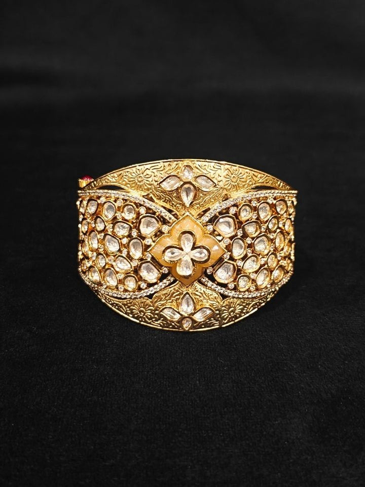 Close-up of an ornate traditional (Gold Polish) Gold Bracelet with Polki and American Diamond. Woman showcasing a premium artificial Polki bracelet for wedding celebrations. Festive Diwali look enhanced with an imitation Polki bracelet.