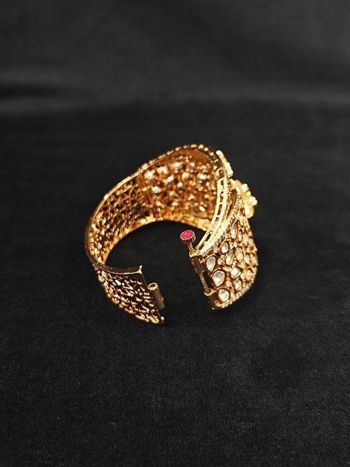 Close-up of an ornate traditional (Gold Polish) Gold Bracelet with Polki and American Diamond. Woman showcasing a premium artificial Polki bracelet for wedding celebrations. Festive Diwali look enhanced with an imitation Polki bracelet.