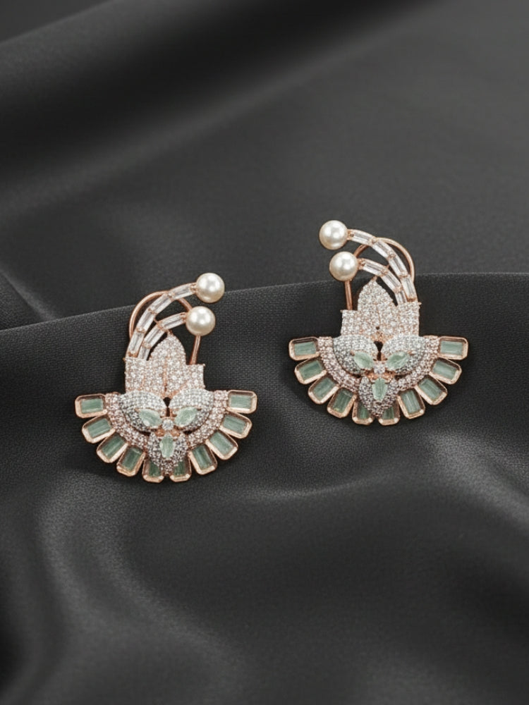 Close-up of an ornate Indo-western Mint Green (Rose gold Polish) Diamond Studs Earrings with American Diamond and Colored Stones. Mehendi function outfit styled with a lightweight American Diamond Studs Earrings. 