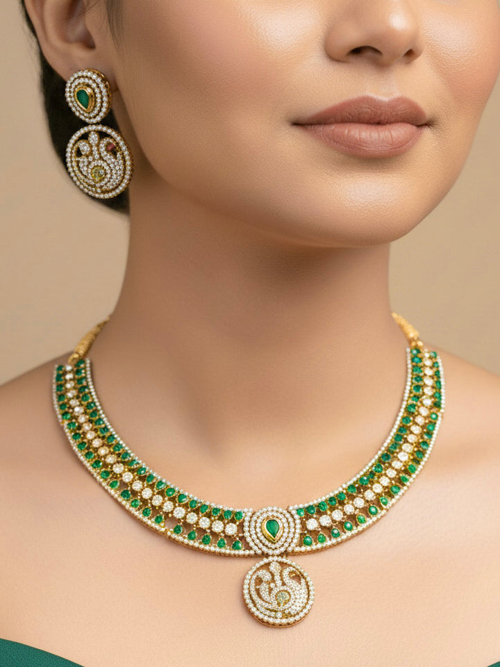 "A woman in a traditional saree, wearing a gorgeous artificial diamond and green colored stone  necklace paired with diamond earrings. This artificial diamond jewelry set offers a traditional yet modern touch for Indian brides, designed to add elegance and sophistication to any occasion."
