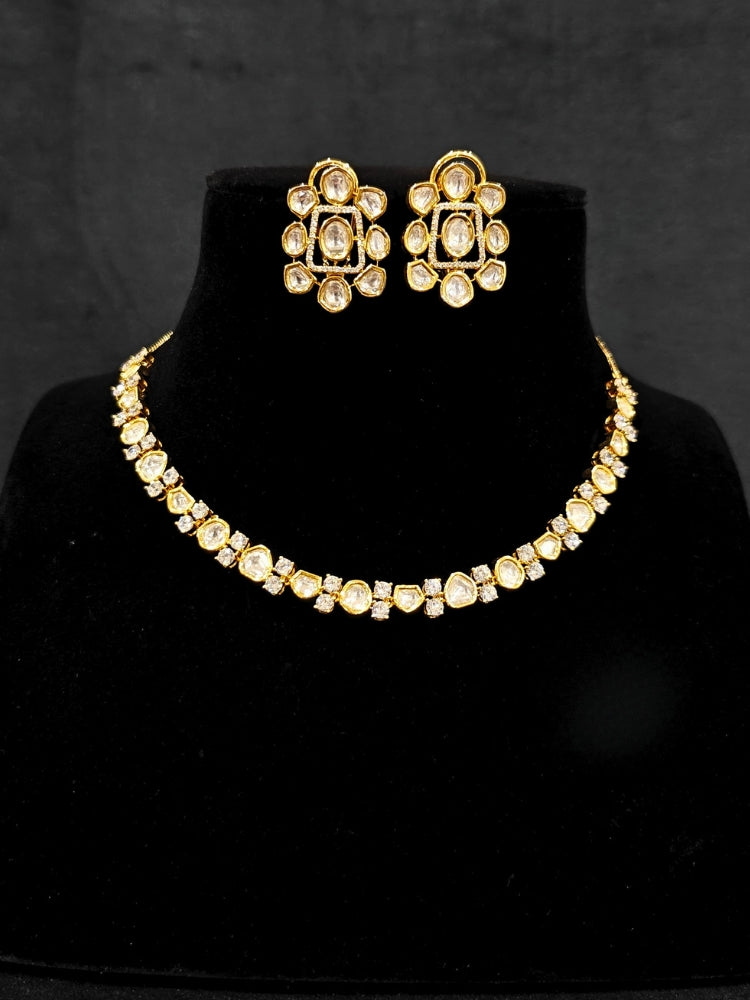 Close-up of an ornate Indo-western Kundan (gold Polish) jewellery set and earrings with American Diamond and Kundan. Indo-western outfit styled with a lightweight Kundan necklace. Reception-ready look featuring elegant Kundan imitation jewelry.