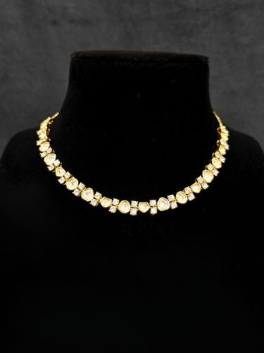 Close-up of an ornate Indo-western Kundan (gold Polish) jewellery set and earrings with American Diamond and Kundan. Indo-western outfit styled with a lightweight Kundan necklace. Reception-ready look featuring elegant Kundan imitation jewelry.