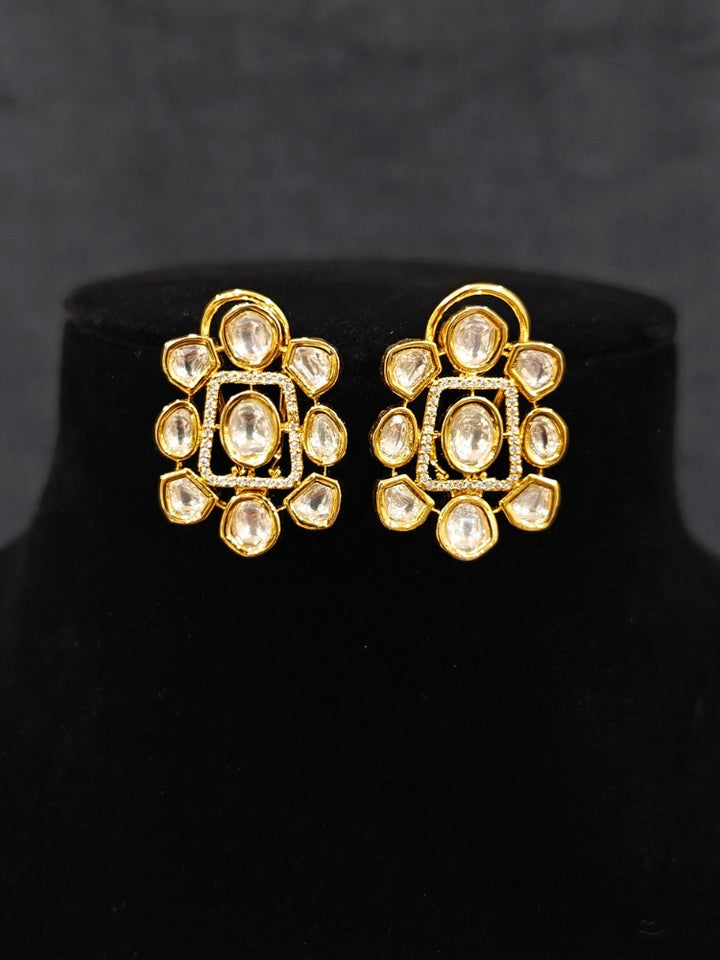 Close-up of an ornate Indo-western Kundan (gold Polish) jewellery set and earrings with American Diamond and Kundan. Indo-western outfit styled with a lightweight Kundan necklace. Reception-ready look featuring elegant Kundan imitation jewelry.
