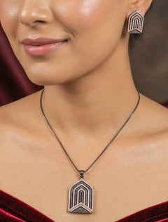 Close-up of a woman wearing an ornate Western Purple and Pink (Black Polish Victorian Finish) Diamond jewellery set and earrings with American Diamonds and Close-Setting. Close-up of a cocktail party look featuring a premium American diamond necklace.