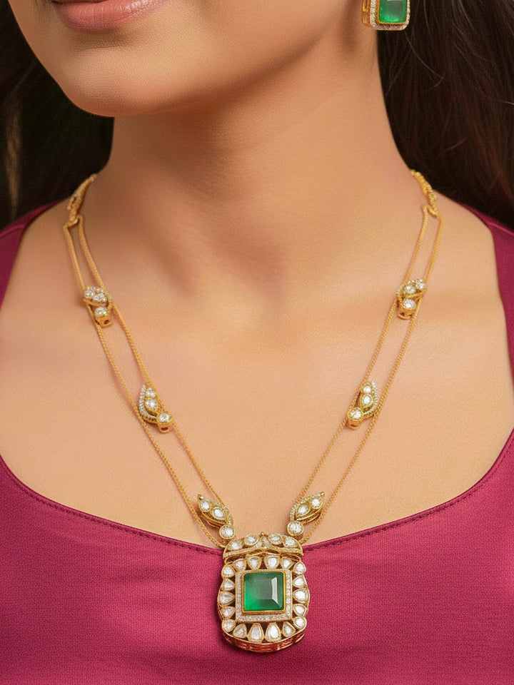 Close-up of a woman wearing an ornate traditional (Gold Polish) Mint Green jewellery set and earrings with Kundan and Colored Stones. Indo-western outfit styled with a lightweight Kundan necklace.  Festive saree styling with a premium artificial Kundan necklace.