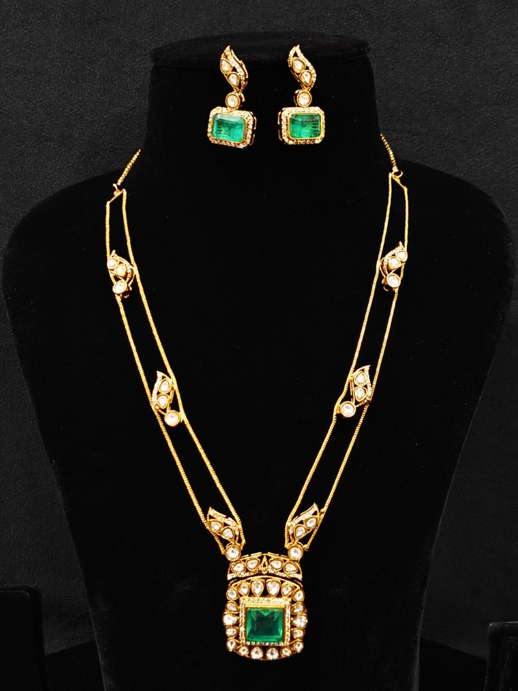 Close-up of an ornate traditional (Gold Polish) Mint Green jewellery set and earrings with Kundan and Colored Stones. Indo-western outfit styled with a lightweight Kundan necklace. Festive saree styling with a premium artificial Kundan necklace.