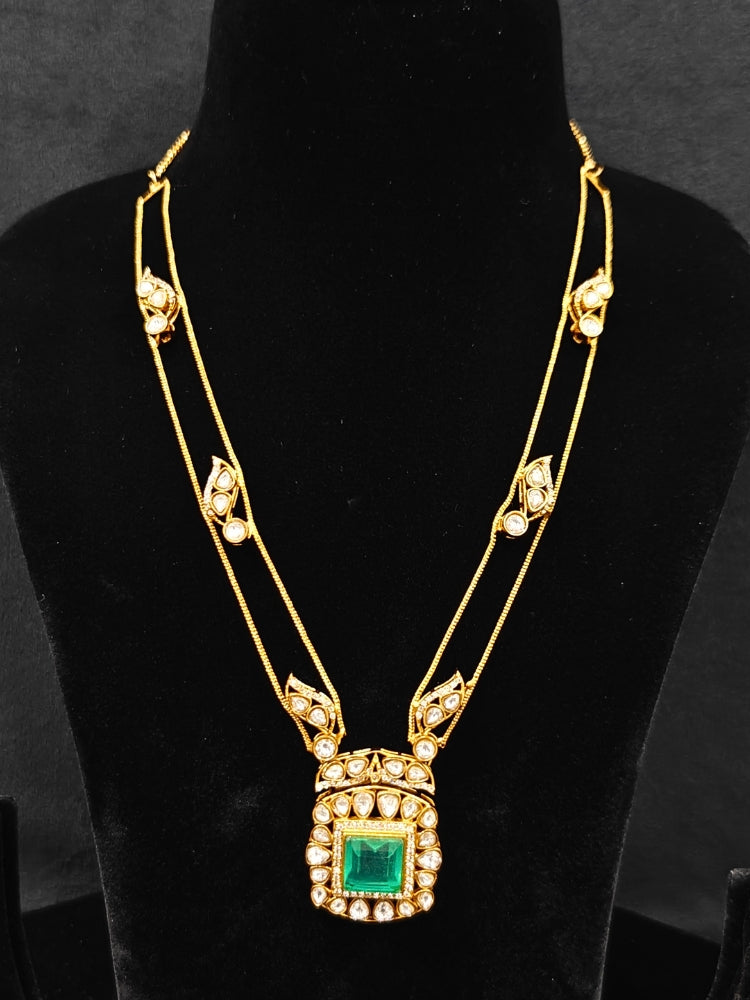 Close-up of an ornate traditional (Gold Polish) Mint Green jewellery set and earrings with Kundan and Colored Stones. Indo-western outfit styled with a lightweight Kundan necklace. Festive saree styling with a premium artificial Kundan necklace.