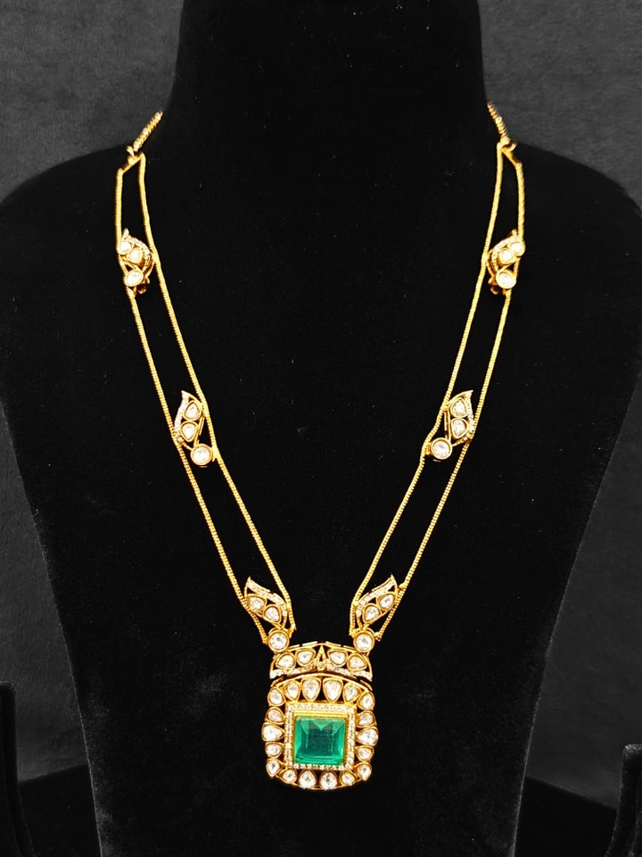Close-up of an ornate traditional (Gold Polish) Mint Green jewellery set and earrings with Kundan and Colored Stones. Indo-western outfit styled with a lightweight Kundan necklace. Festive saree styling with a premium artificial Kundan necklace.