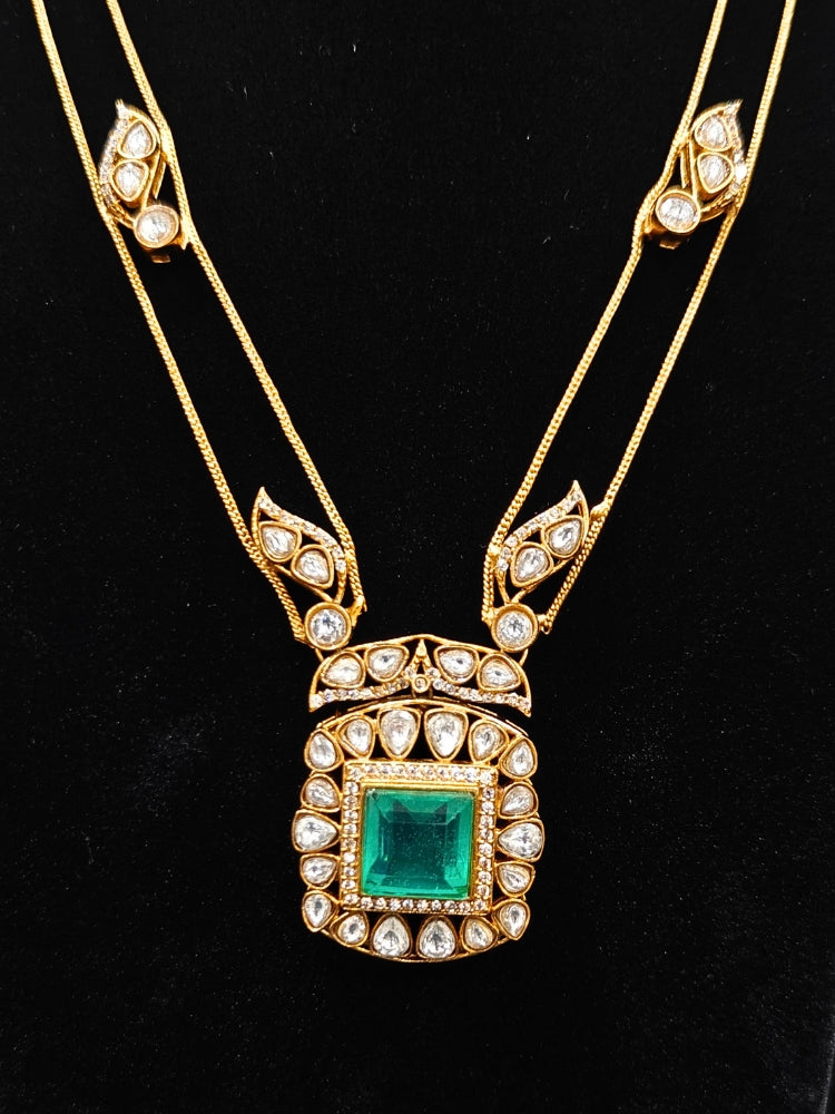 Close-up of an ornate traditional (Gold Polish) Mint Green jewellery set and earrings with Kundan and Colored Stones. Indo-western outfit styled with a lightweight Kundan necklace. Festive saree styling with a premium artificial Kundan necklace.