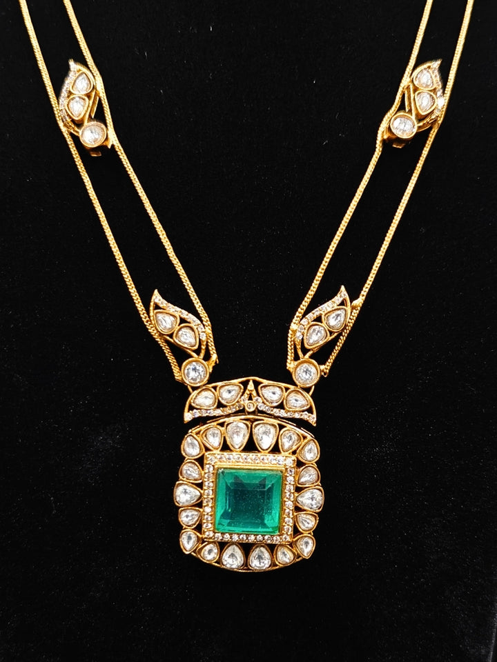 Close-up of an ornate traditional (Gold Polish) Mint Green jewellery set and earrings with Kundan and Colored Stones. Indo-western outfit styled with a lightweight Kundan necklace. Festive saree styling with a premium artificial Kundan necklace.