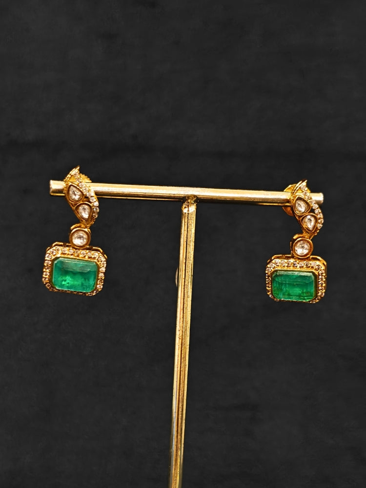 Close-up of an ornate traditional (Gold Polish) Mint Green jewellery set and earrings with Kundan and Colored Stones. Indo-western outfit styled with a lightweight Kundan necklace. Festive saree styling with a premium artificial Kundan necklace.
