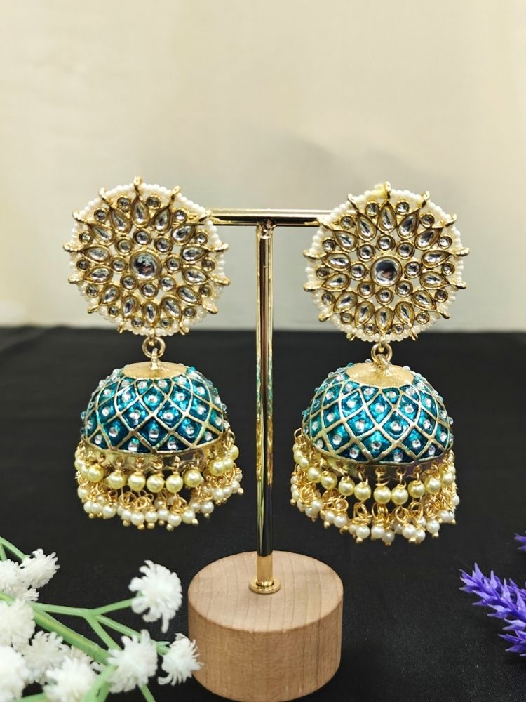Close-up of an ornate traditional Teel Blue Meenakari gold Long Earrings with Pearls, Kundan and Meenakari. Wedding guest wearing a Meenakari artificial Earrings. Wedding function styling with a premium Meenakari imitation Earrings.