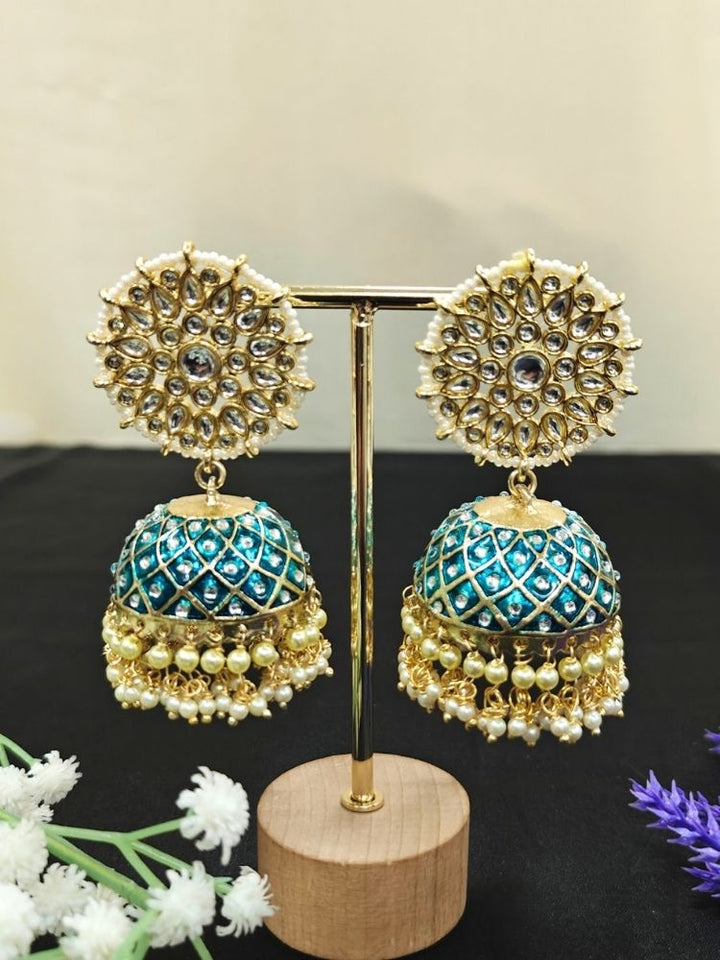 Close-up of an ornate traditional Teel Blue Meenakari gold Long Earrings with Pearls, Kundan and Meenakari. Wedding guest wearing a Meenakari artificial Earrings. Wedding function styling with a premium Meenakari imitation Earrings.