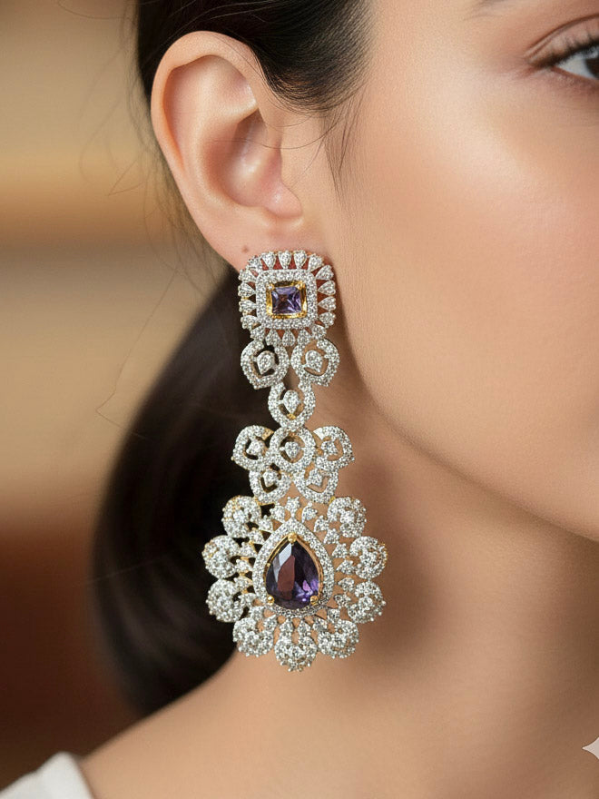 A stunning woman wearing a glamorous artificial diamond necklace with purple colored stone paired with chic earrings and maangtikka, perfect for bridal wear. This high-quality artificial diamond jewelry set is the ideal choice for modern brides looking for a budget-friendly option with timeless sparkle.
