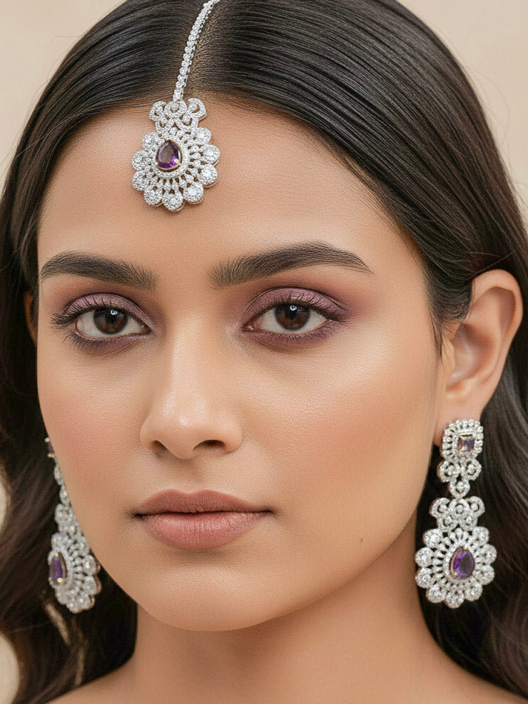 Close-up of a woman wearing a sparkling artificial diamond necklace with purple colored stone and diamond earrings and maangtikka set, designed to offer a radiant, elegant look for any formal occasion or Indian wedding. This affordable diamond jewelry provides a flawless, luxurious alternative to natural diamonds.