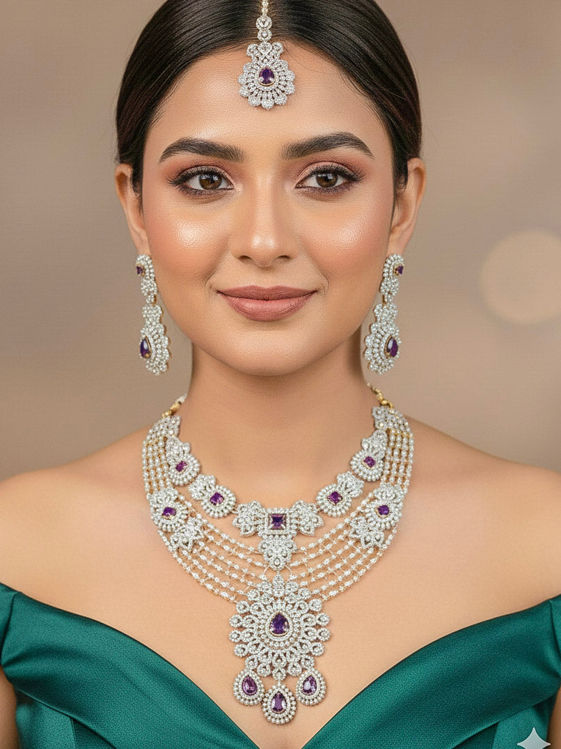 A stunning woman wearing a glamorous artificial diamond necklace with purple colored stone paired with chic earrings and maangtikka, perfect for bridal wear. This high-quality artificial diamond jewelry set is the ideal choice for modern brides looking for a budget-friendly option with timeless sparkle.