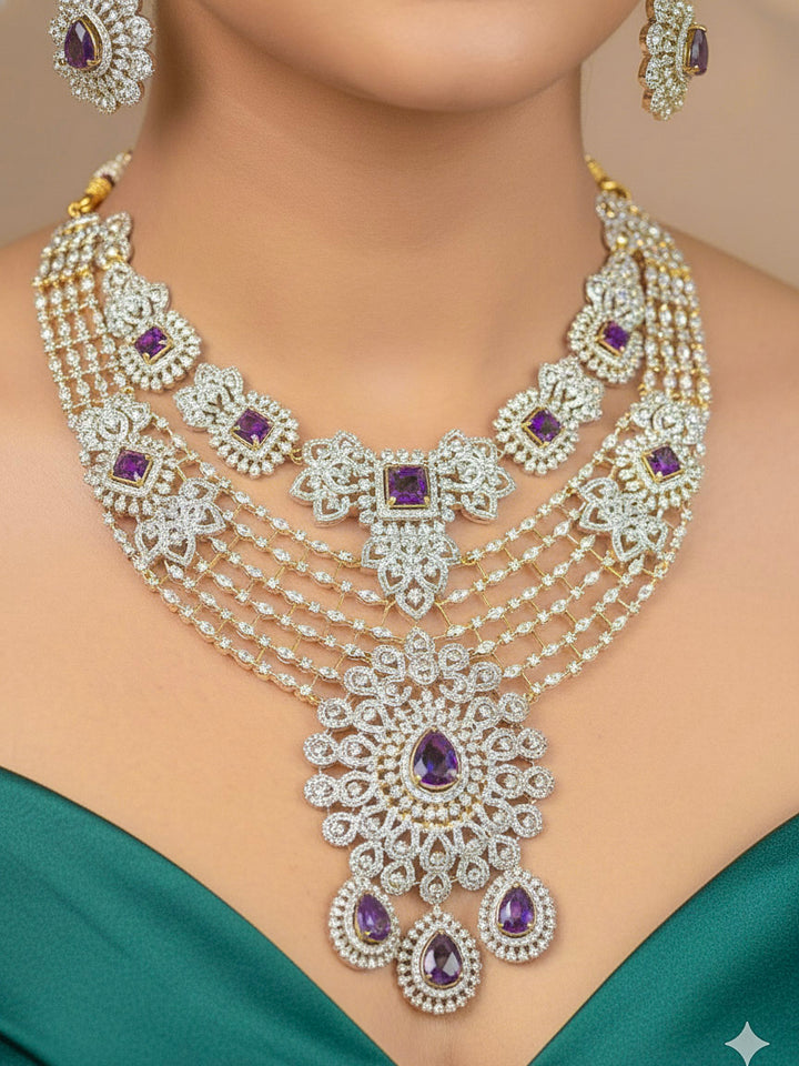 A bride-to-be wearing an exquisite artificial diamond necklace with purple colored stone and matching earrings and maangtikka, designed for the perfect engagement look. This stunning artificial diamond jewelry set offers luxury and sophistication while being an affordable alternative to natural diamonds.