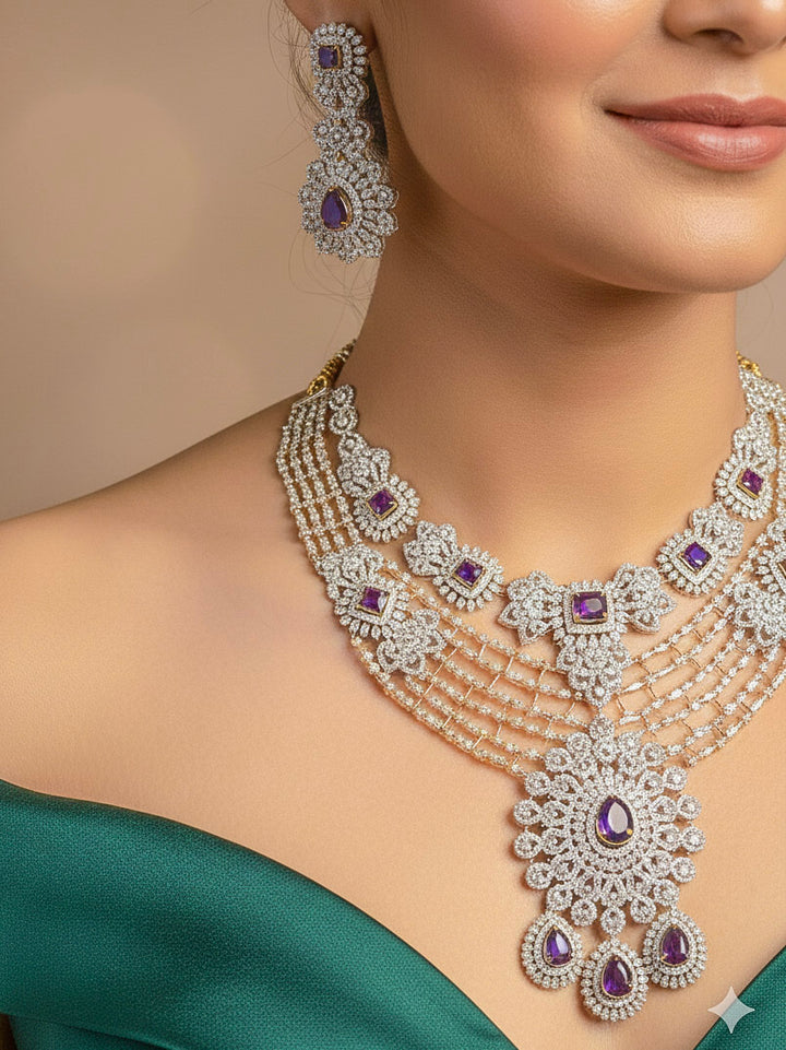 A close-up shot of a bride wearing a stunning artificial diamond necklace with purple colored stone and matching earrings and matching maangtikka, designed to complement bridal attire. This affordable diamond necklace set is perfect for brides seeking luxurious but cost-effective wedding jewelry in India.