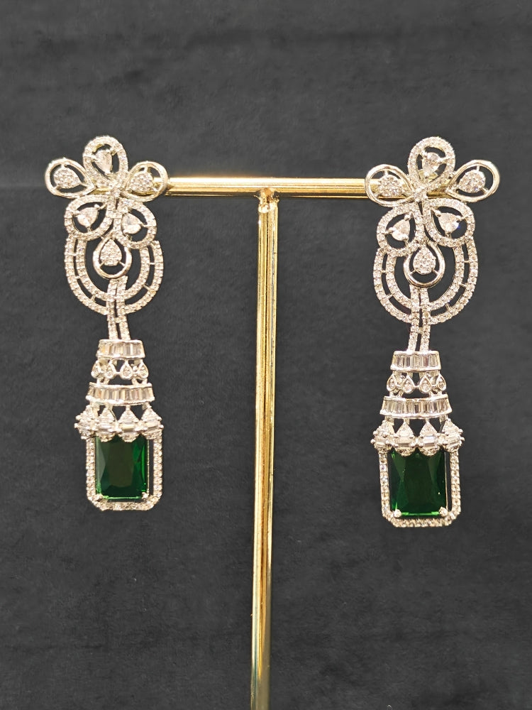 An exquisite artificial diamond necklace with green colored stone and matching earrings, designed for the perfect engagement look. This stunning artificial diamond jewelry set offers luxury and sophistication while being an affordable alternative to natural diamonds."