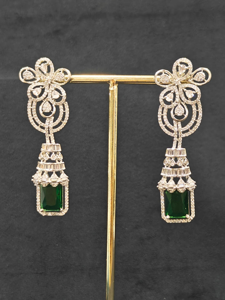 An exquisite artificial diamond necklace with green colored stone and matching earrings, designed for the perfect engagement look. This stunning artificial diamond jewelry set offers luxury and sophistication while being an affordable alternative to natural diamonds."