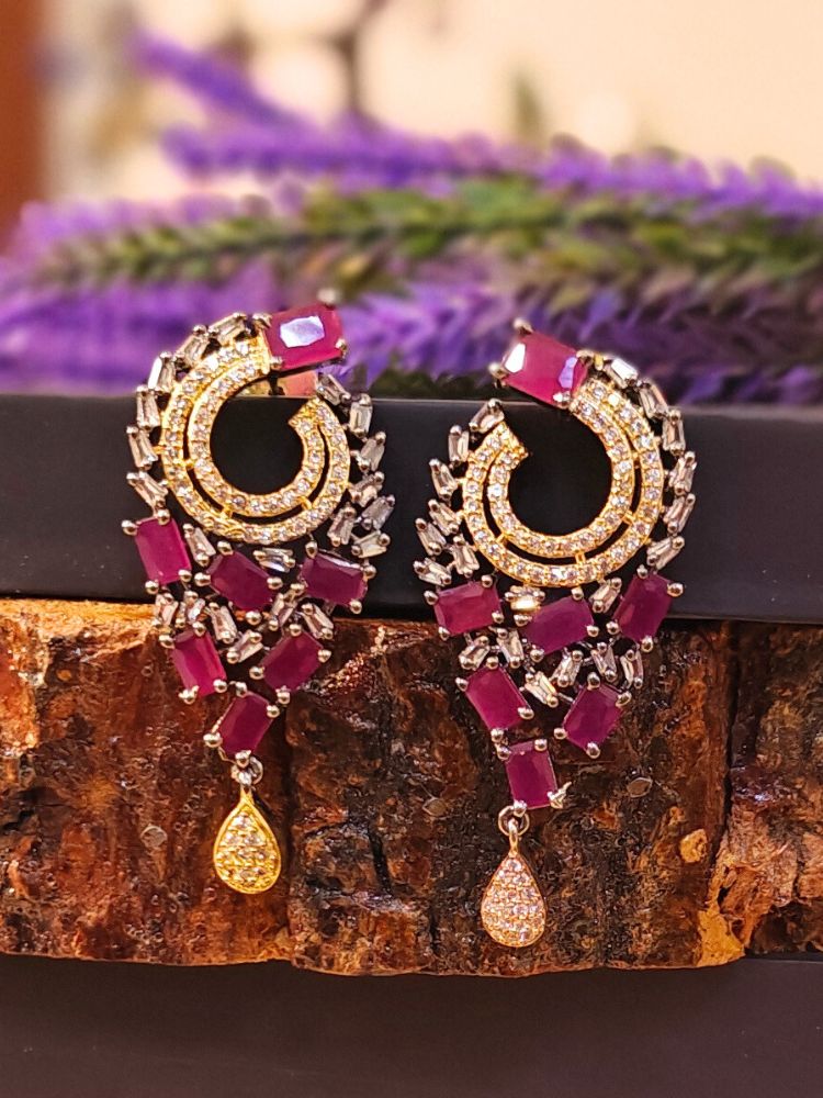 Close-up of an ornate Indo-Western (Black Polish Victorian Finish) Pink Earrings with American Diamond and Pink Colored Stones. Indo-western outfit styled with a statement Colored Stone Earrings set. Close-up shot of a high-quality Colored Stone artificial Earrings set worn for festive celebrations.