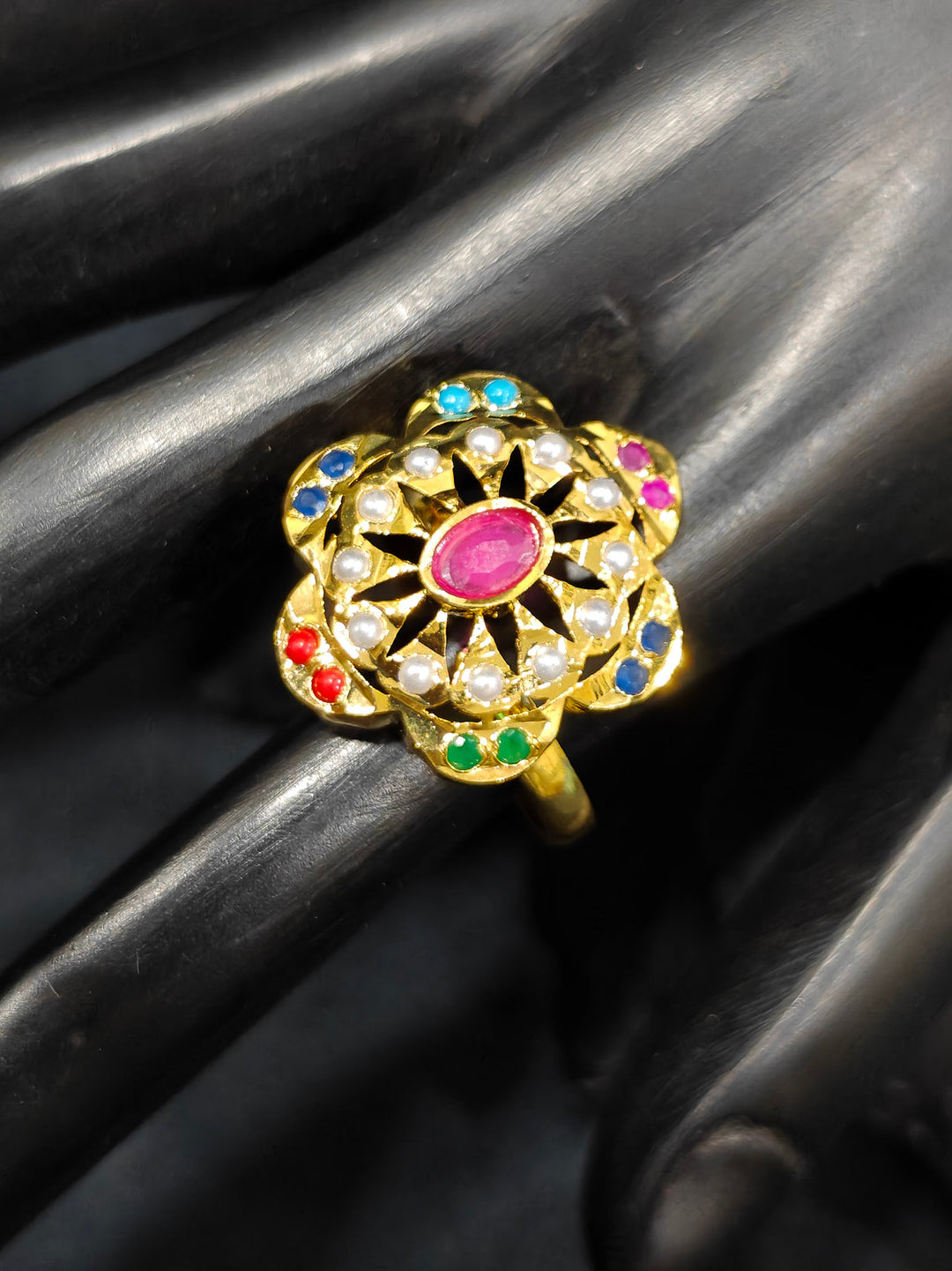 Close-up of an ornate traditional Navratan jadau gold Bracelet with matched Ring with pearls and Color Stone. A premium artificial Jadau bracelet with Ring for wedding celebrations. Close-up of a high-quality imitation Jadau bracelet with Ring for festive wear.