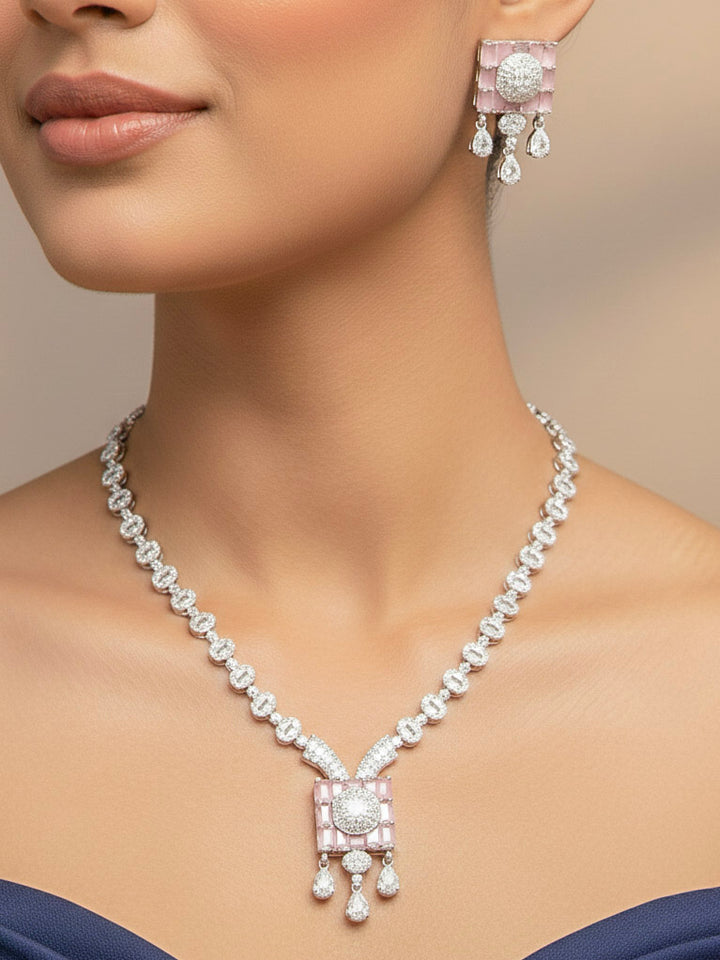 A woman showcasing a beautiful artificial diamond necklace with mint pink colored stone and earrings set, ideal for festivals, family gatherings, and special celebrations in India. This elegant diamond jewelry provides the perfect blend of sparkle and tradition, with a modern twist.
