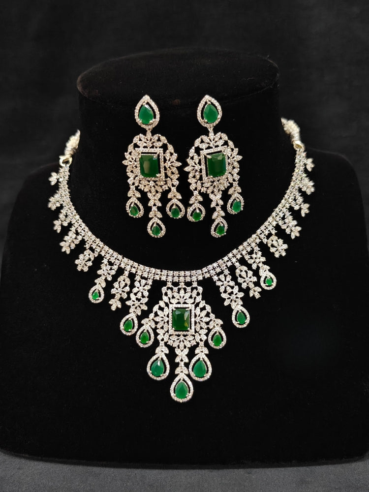 "An elegant artificial diamond necklace with green colored stone and matching earrings. This premium artificial diamond jewelry set is perfect for special occasions, from Indian weddings to engagement parties, offering sophisticated glamour without the high price tag."