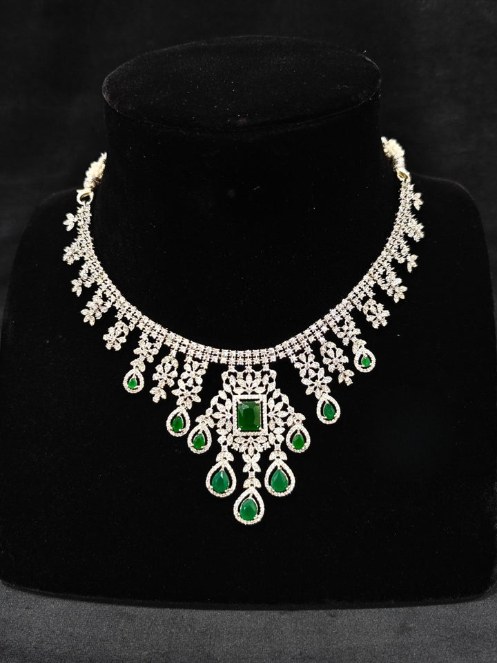 "An elegant artificial diamond necklace with green colored stone and matching earrings. This premium artificial diamond jewelry set is perfect for special occasions, from Indian weddings to engagement parties, offering sophisticated glamour without the high price tag."