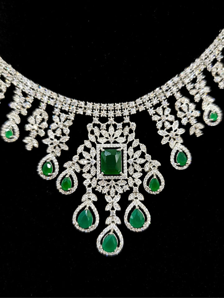  "An elegant artificial diamond necklace with green colored stone and matching earrings. This premium artificial diamond jewelry set is perfect for special occasions, from Indian weddings to engagement parties, offering sophisticated glamour without the high price tag."
