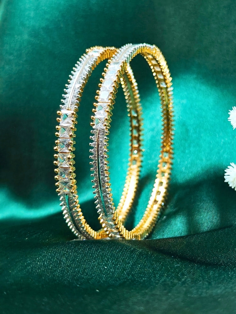 Close-up of an ornate  Indo-Western (Gold Polish) Diamond Bangles with American Diamond. Cocktail party outfit paired with sparkling artificial American Diamond Bangles. Elegant party wear styled with high-quality imitation American Diamond Bangles.