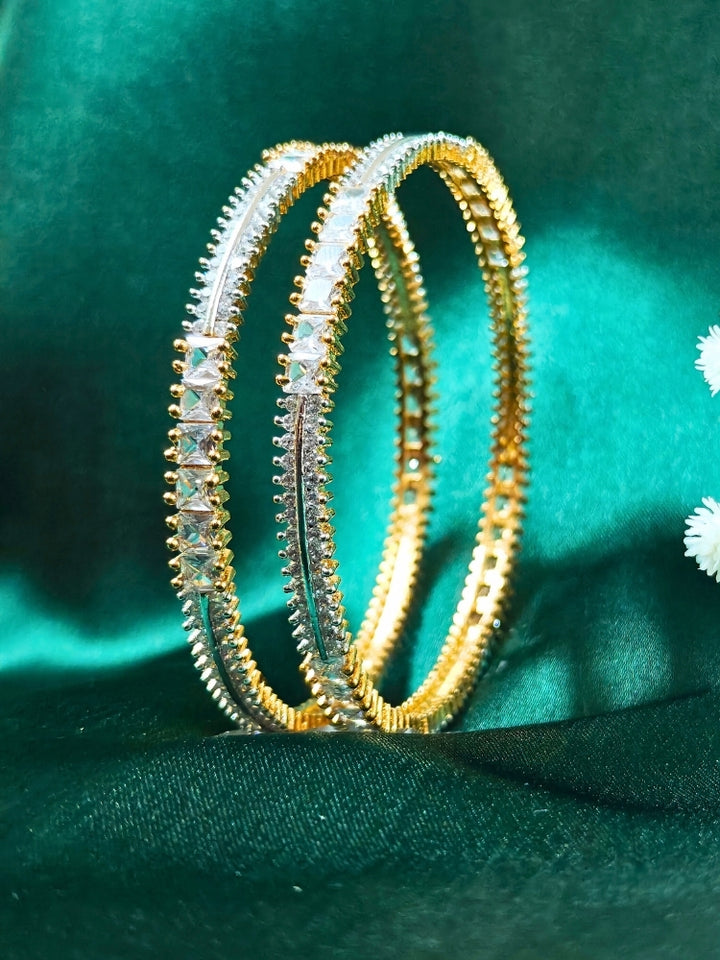 Close-up of an ornate  Indo-Western (Gold Polish) Diamond Bangles with American Diamond. Cocktail party outfit paired with sparkling artificial American Diamond Bangles. Elegant party wear styled with high-quality imitation American Diamond Bangles.