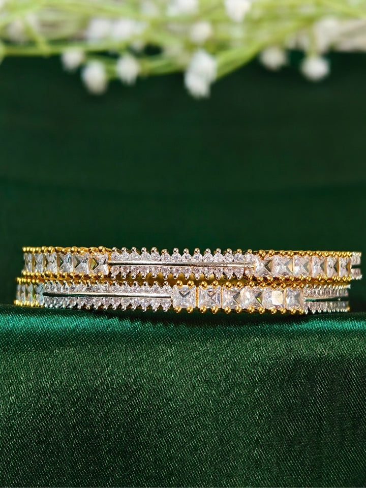 Close-up of an ornate  Indo-Western (Gold Polish) Diamond Bangles with American Diamond. Cocktail party outfit paired with sparkling artificial American Diamond Bangles. Elegant party wear styled with high-quality imitation American Diamond Bangles.