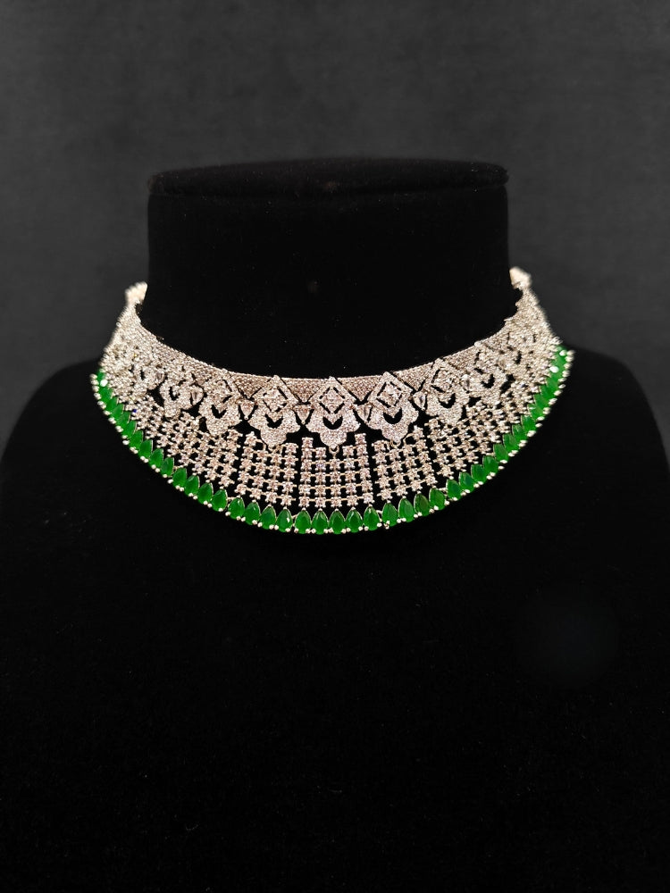 A glamorous artificial diamond and green colored stone necklace paired with chic earrings, perfect for bridal wear. This high-quality artificial diamond jewelry set is the ideal choice for modern brides looking for a budget-friendly option with timeless sparkle.
