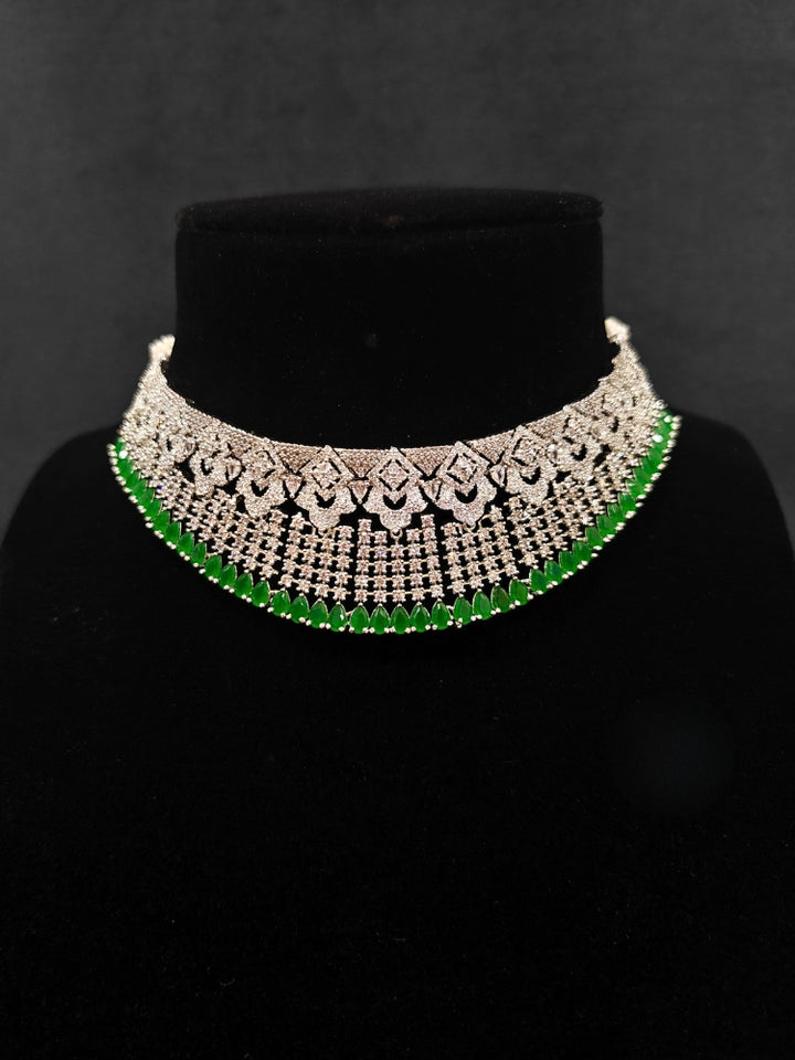 A glamorous artificial diamond and green colored stone necklace paired with chic earrings, perfect for bridal wear. This high-quality artificial diamond jewelry set is the ideal choice for modern brides looking for a budget-friendly option with timeless sparkle.