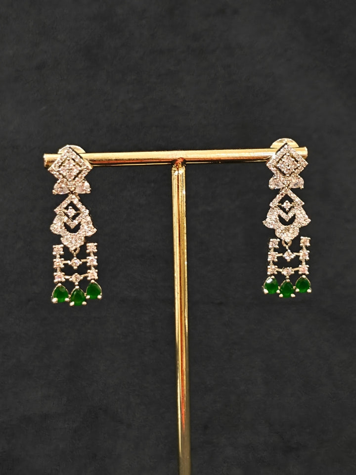 A glamorous artificial diamond and green colored stone necklace paired with chic earrings, perfect for bridal wear. This high-quality artificial diamond jewelry set is the ideal choice for modern brides looking for a budget-friendly option with timeless sparkle.