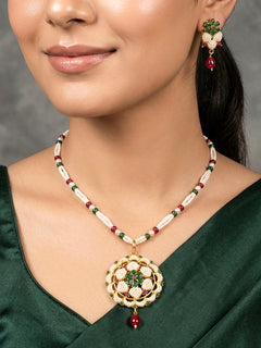 Close-up of a woman wearing an ornate traditional Pearl Pendant Set  earrings with Pearl and Colored Stones. Festive celebration look enhanced with traditional Pearl jewelry. Close-up of detailed enamel craftsmanship in Pearl jewelry.