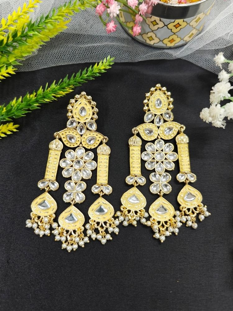 Close-up of an ornate traditional Yellow Meenakari gold Long Earrings with Pearls, Kundan and Meenakari. Saree styling inspiration with a statement Meenakari Earrings. Close-up of enamel work in Meenakari artificial wedding Earrings.
