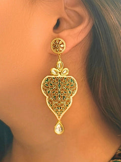 Close-up of a woman wearing an ornate traditional Green Meenakari Earrings with Kundan, Meeenakari and Filigree. Festive Diwali look styled with premium artificial Meenakari earrings. Close-up of anti-tarnish artificial Meenakari earrings for festive celebrations.