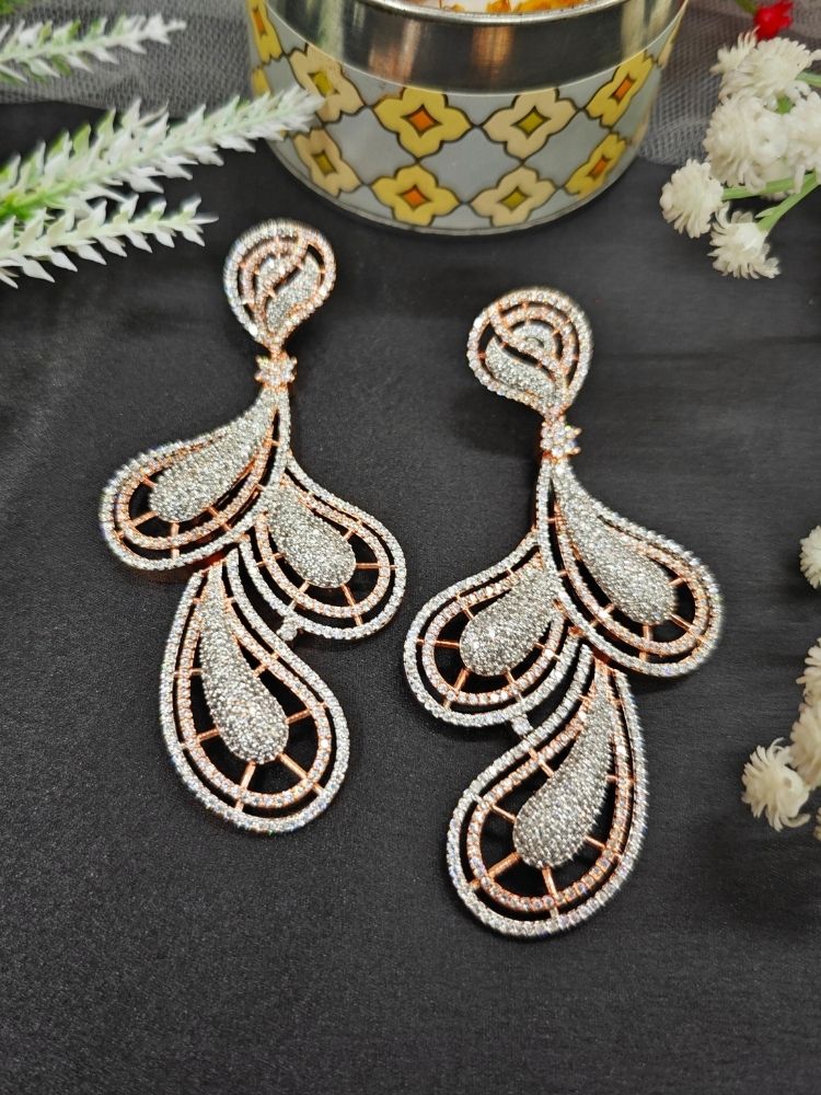 Close-up of an ornate Western American Diamond Rose Gold Earrings with American Diamond. Elegant party wear styled with high-quality imitation American Diamond earrings. Close-up of American diamond earrings styled for a reception party.